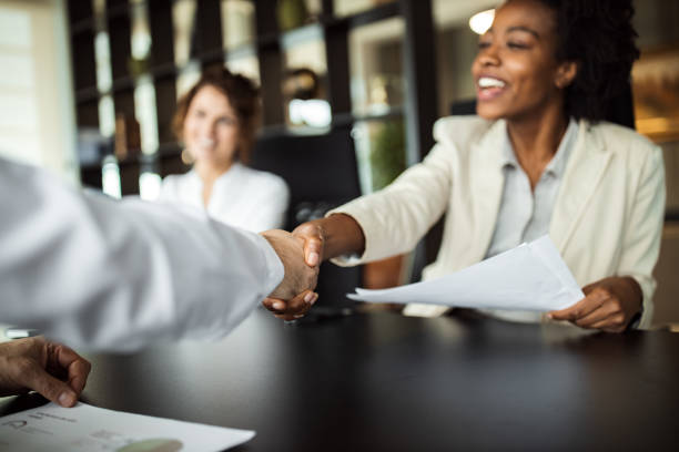 Business woman making plans with somebody, shaking hands. Infini-rh ave cindy lo re